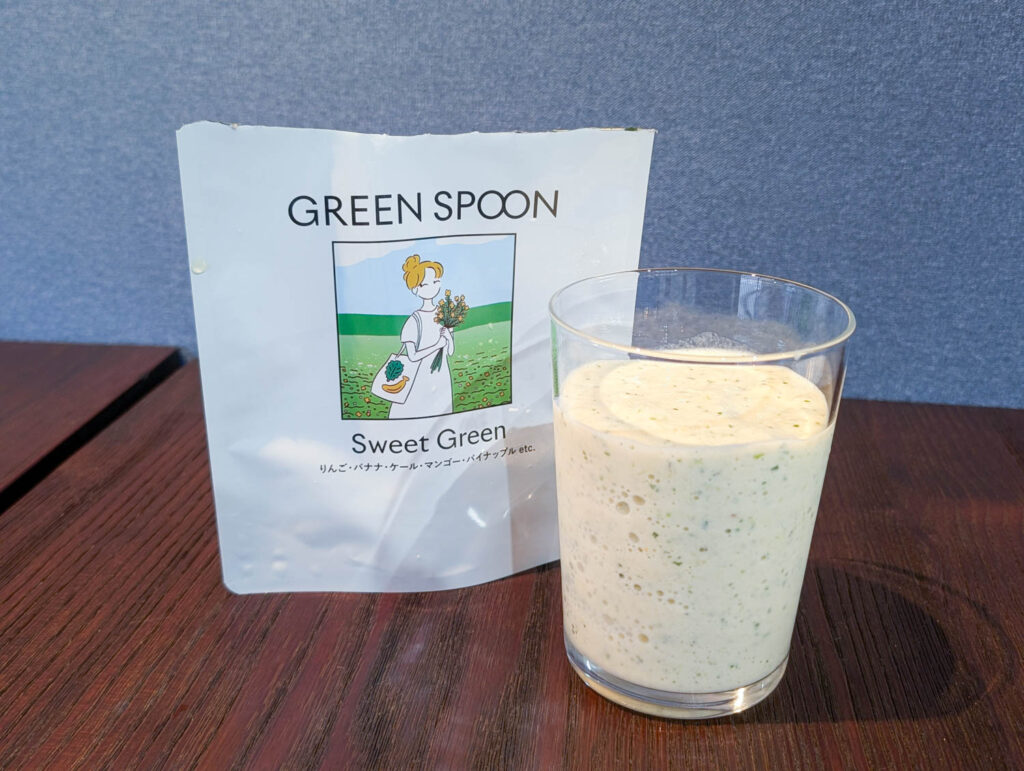 GREEN SPOONのスムージーのパッケージとグラスに注いだスムージー